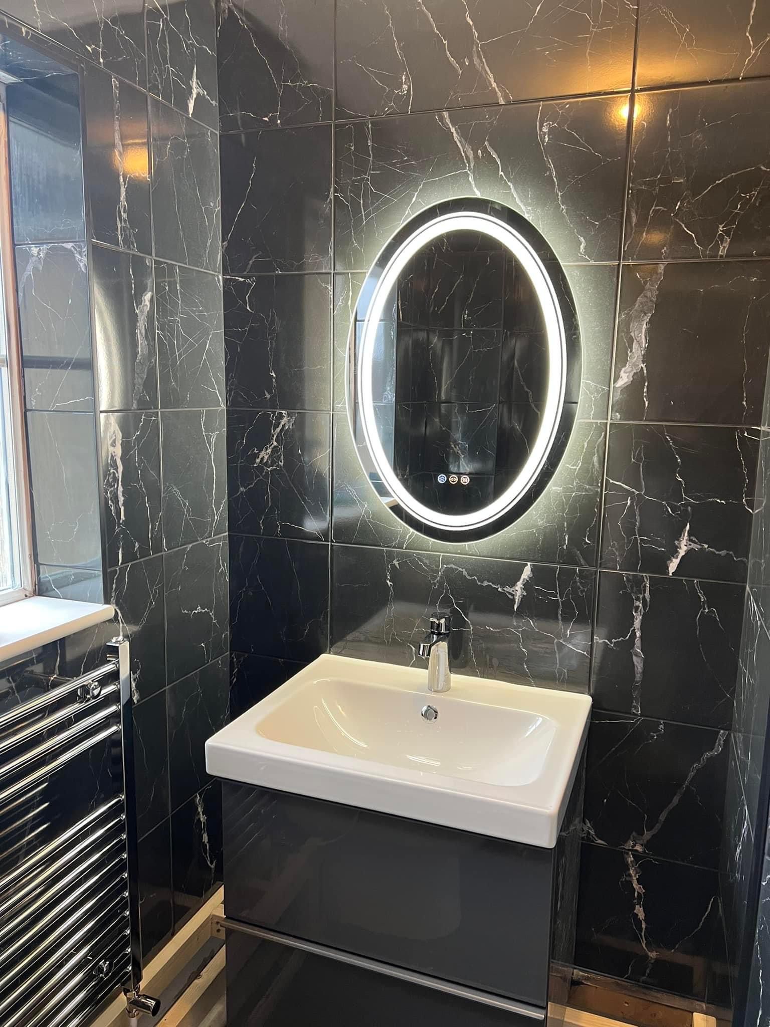Black marble bathroom with LED mirror