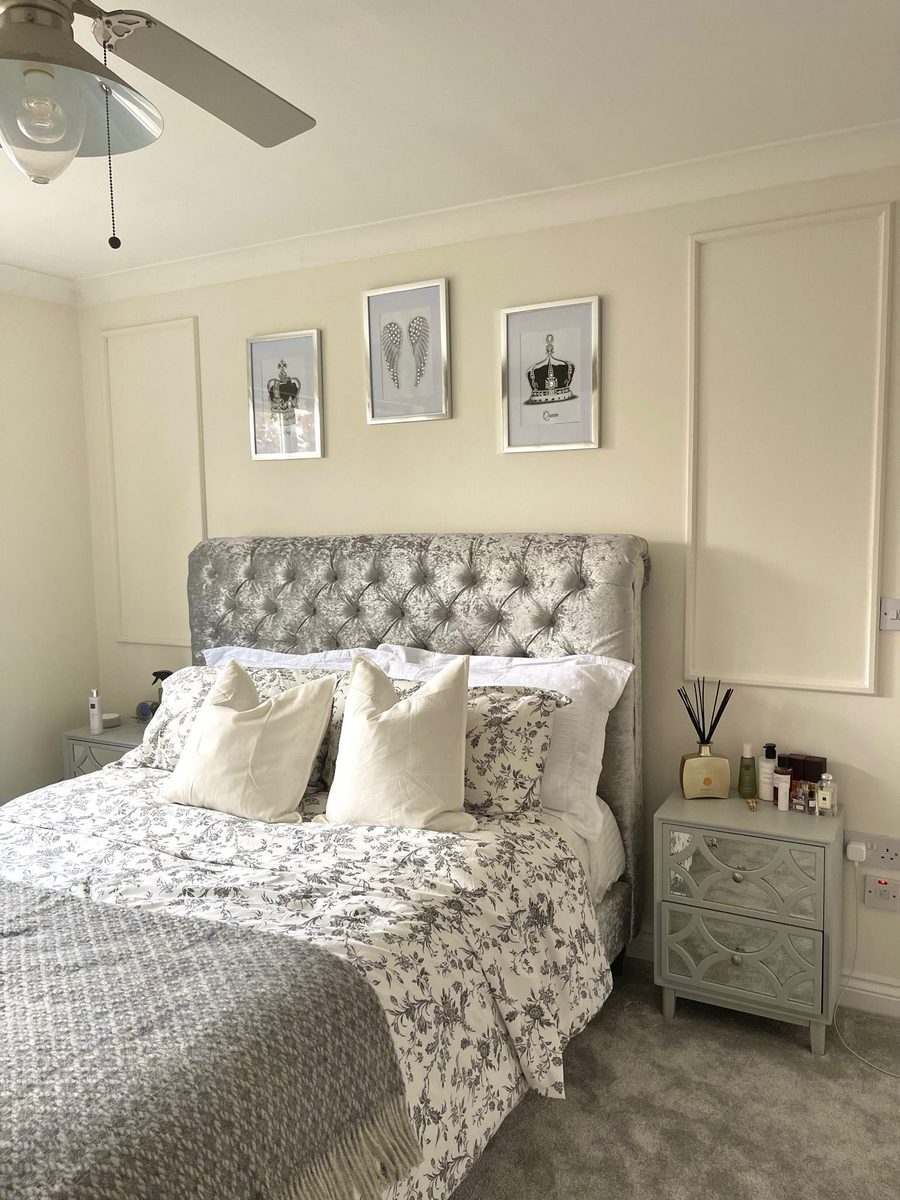 Bedroom with silver crushed velvet headboard and wall panelling