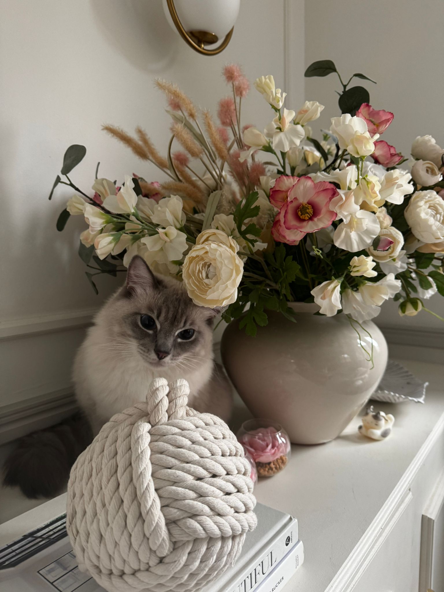 E-design result by Maison Zohora — console table with large floral arrangement, candle and decorative objects
